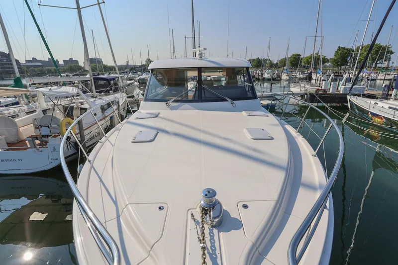 Slide: The Image of 2016 Riviera 525 SUV yacht docked in a marina, surrounded by other boats. - 32