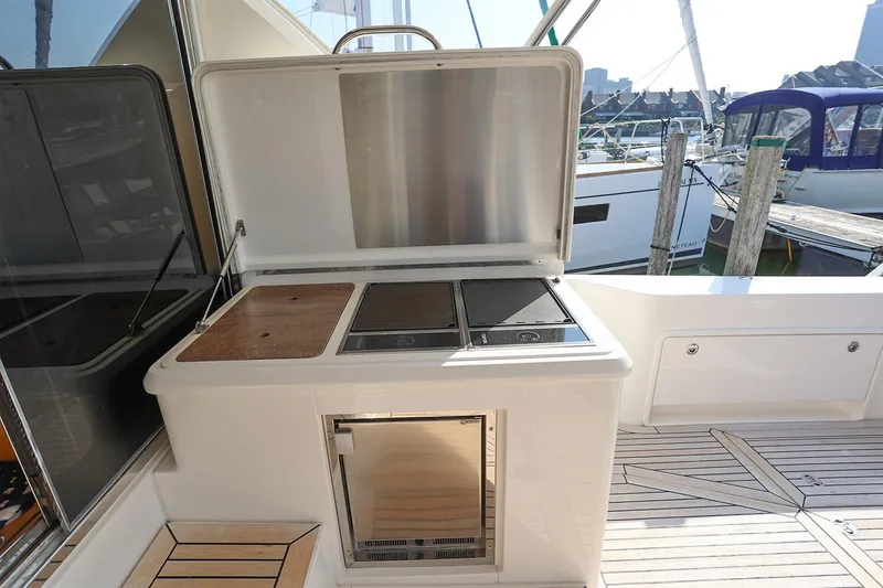 Slide: The Image of Outdoor kitchen on 2016 Riviera 525 SUV yacht with grill and storage. - 41