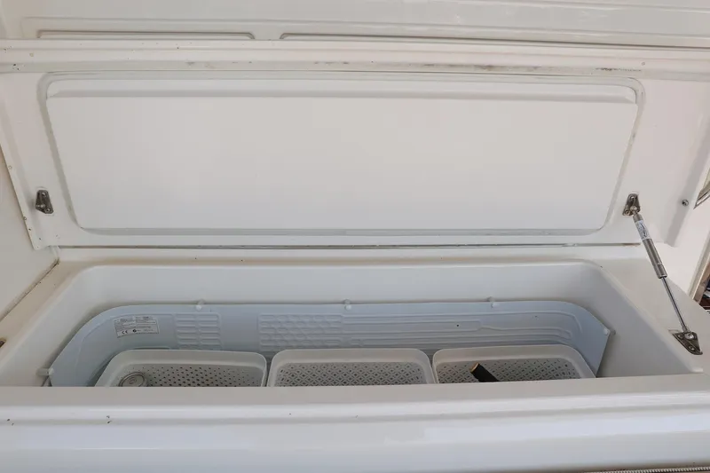 Slide: The Image of Open storage compartment in 2016 Riviera 525 SUV boat. - 42