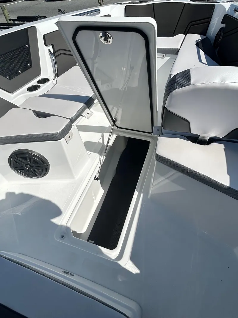 Slide: The Image of 2024 Scarab 255 Open ID boat interior with open storage compartment. - 13