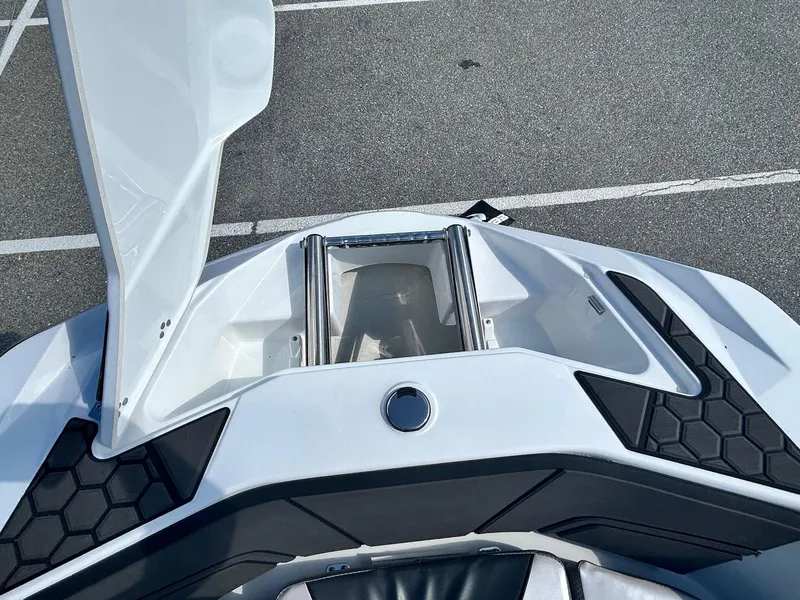 Slide: The Image of 2024 Scarab 255 Open ID boat with open storage compartment. - 14