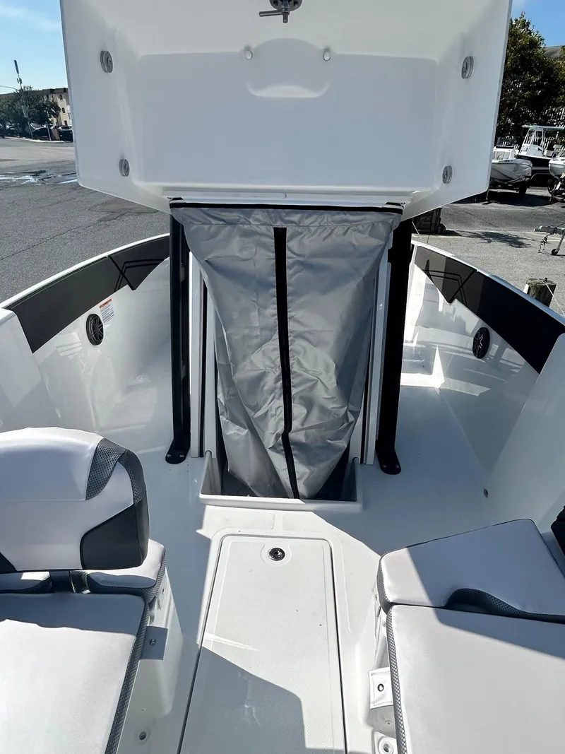 Slide: The Image of 2024 Scarab 255 Open ID boat interior with storage compartment. - 16