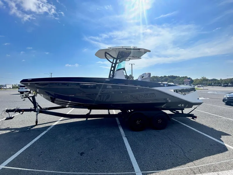 Slide: The Image of 2024 Scarab 255 Open ID boat on a trailer in a parking lot. - 4