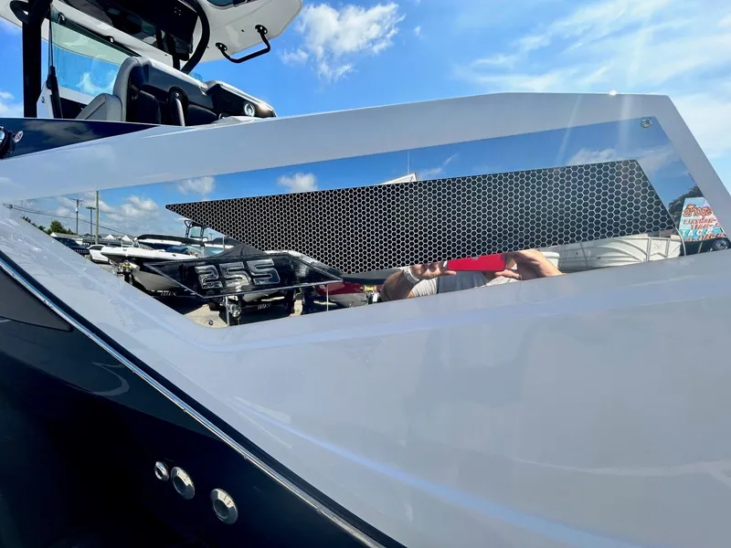 Slide: The Image of 2024 Scarab 255 Open ID boat exterior detail with sleek design and reflective surface. - 8