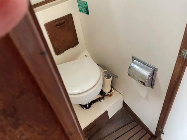 Slide: The Image of 1982 Sabre 30 MK I boat bathroom with toilet and wooden flooring. - 11