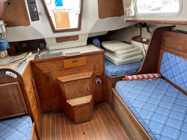 Slide: The Image of Interior of 1982 Sabre 30 MK I sailboat with wood finish and blue cushions. - 13