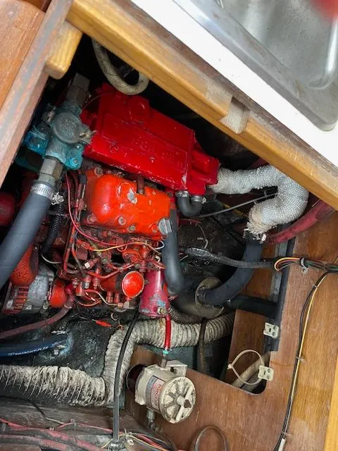 Slide: The Image of Engine compartment of a 1982 Sabre 30 MK I sailboat, showing red engine and wiring. - 14