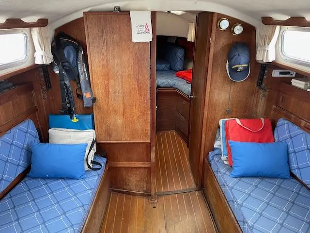 Slide: The Image of Interior of 1982 Sabre 30 MK I sailboat with blue cushions and wooden finish. - 9