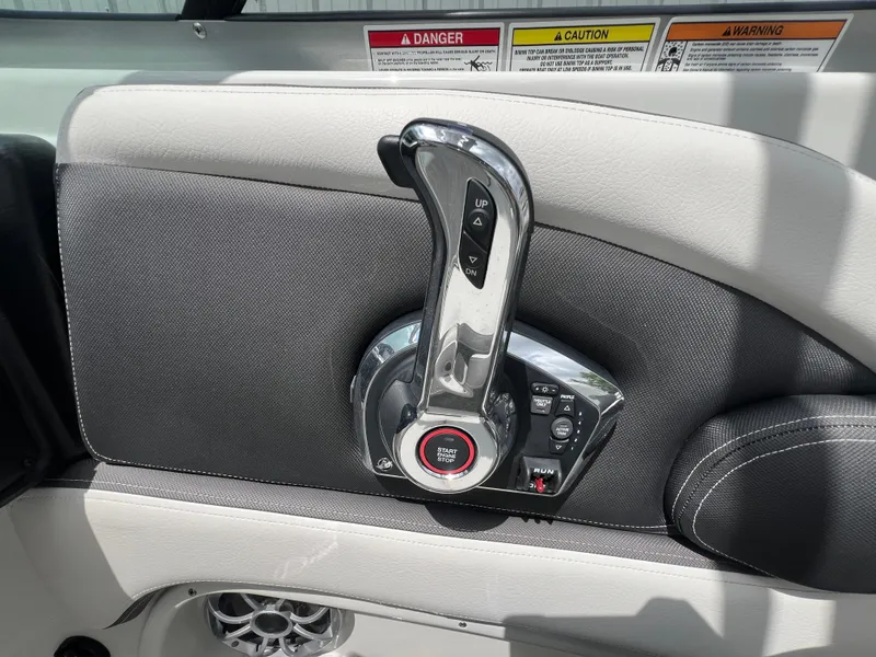 Slide: The Image of 2024 Crownline 250 XSS boat throttle control and dashboard. - 18