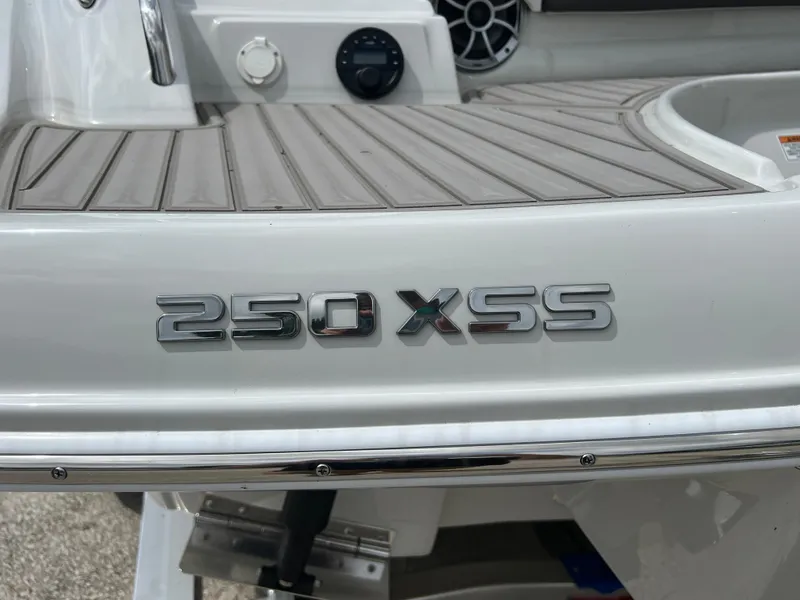 Slide: The Image of 2024 Crownline 250 XSS boat model emblem on deck. - 19