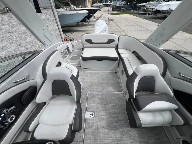 Slide: The Image of 2024 Crownline 250 XSS boat interior with white and gray seating. - 2