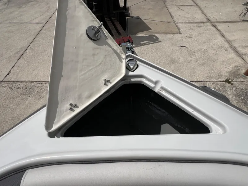 Slide: The Image of Open storage compartment on a 2024 Crownline 250 XSS boat. - 21
