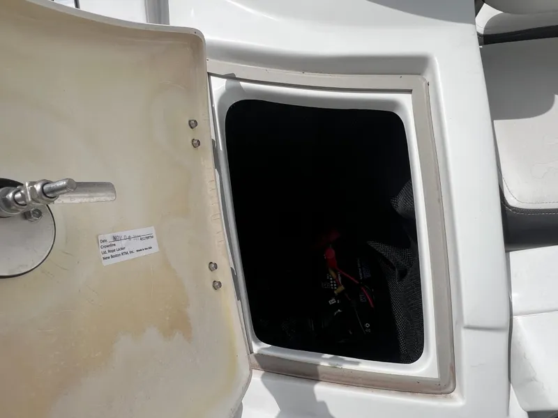 Slide: The Image of Open storage compartment on a 2024 Crownline 250 XSS boat. - 22