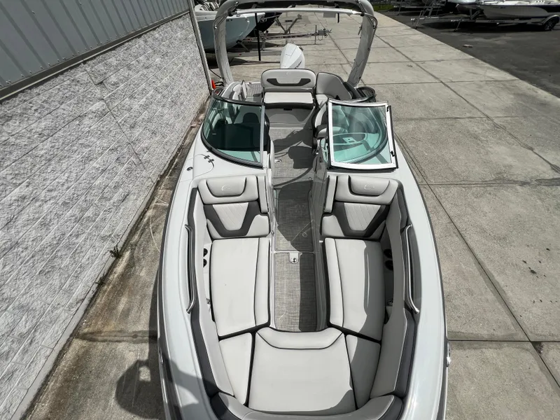 Slide: The Image of 2024 Crownline 250 XSS boat with spacious seating and modern design. - 3