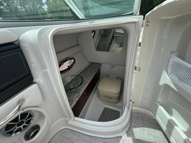 Slide: The Image of 2024 Crownline 250 XSS boat interior with cabin and toilet. - 7