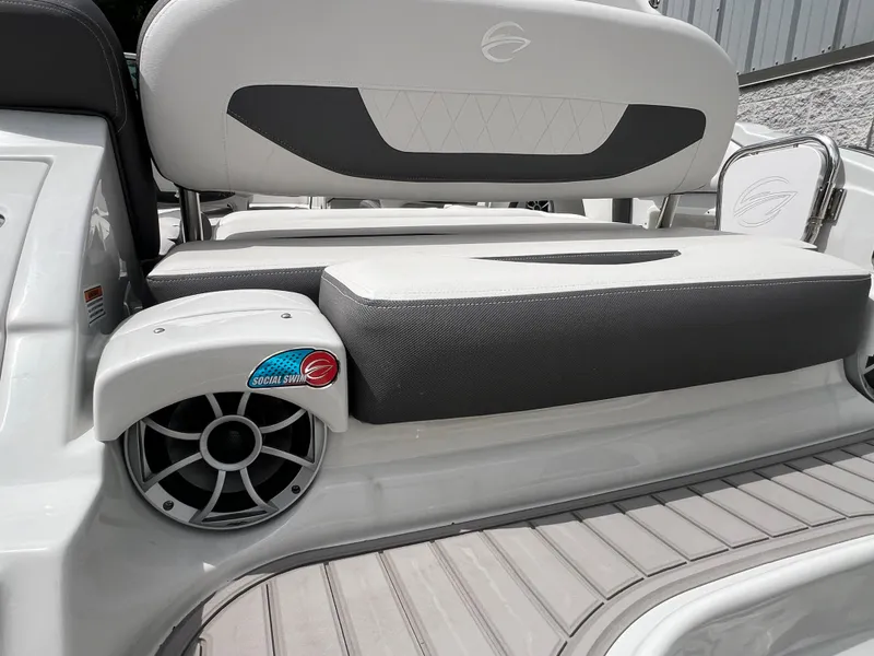 Slide: The Image of 2024 Crownline 250 XSS boat interior with cushioned seating and speaker system. - 8