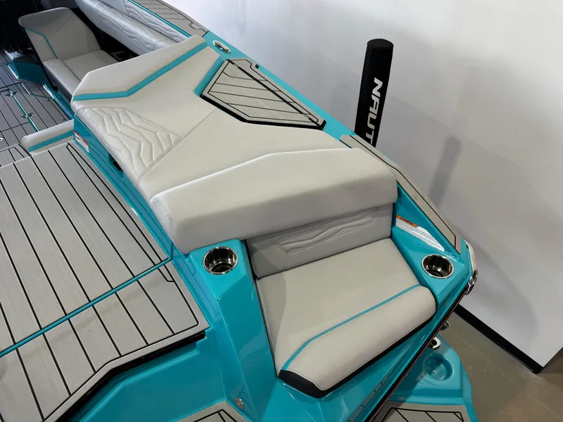 Slide: The Image of 2025 Nautique Super Air Nautique G25 boat interior with teal and gray seating. - 11