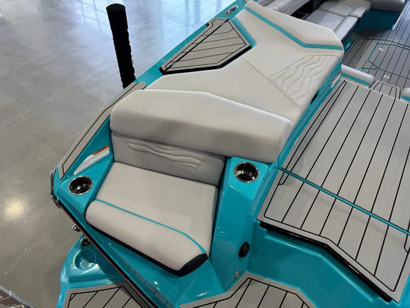 Slide: The Image of 2025 Nautique Super Air Nautique G25 boat interior with teal and gray seating. - 12