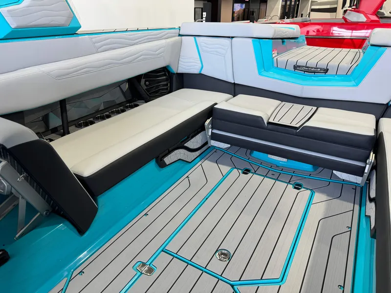 Slide: The Image of Interior seating of 2025 Nautique Super Air Nautique G25 boat with teal and gray accents. - 15