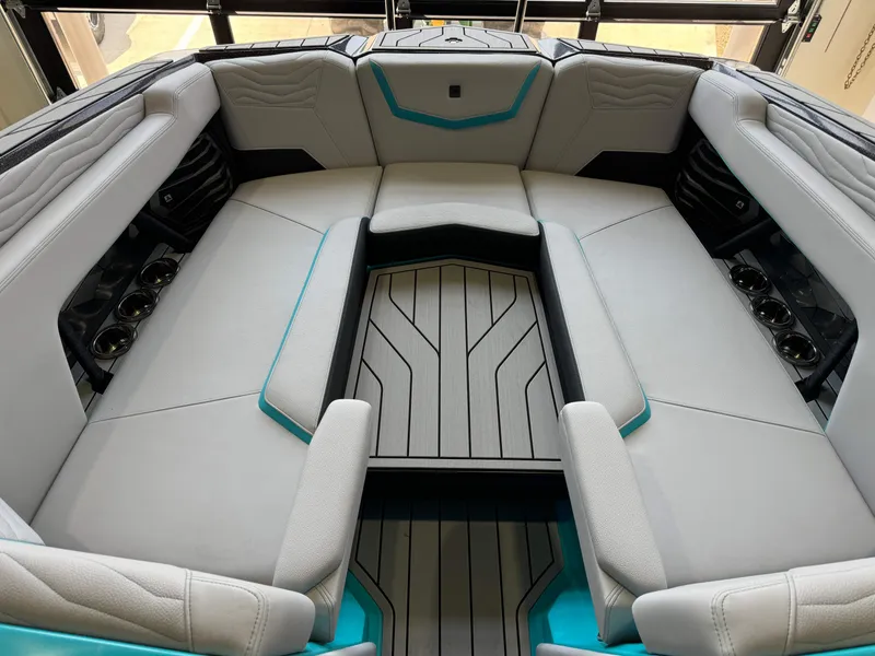 Slide: The Image of Interior seating of 2025 Nautique Super Air Nautique G25 boat with cup holders. - 17
