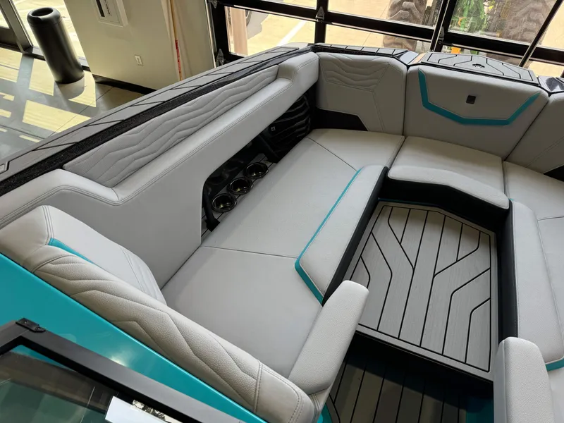 Slide: The Image of Interior seating of 2025 Nautique Super Air Nautique G25 boat with modern design and cup holders. - 19