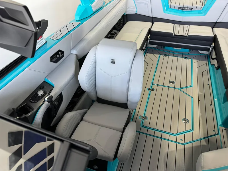 Slide: The Image of Interior of 2025 Nautique Super Air Nautique G25 boat with modern seating and sleek design. - 21