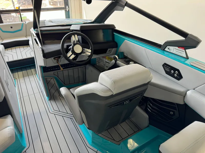 Slide: The Image of 2025 Nautique Super Air Nautique G25 boat interior with modern helm and seating. - 24