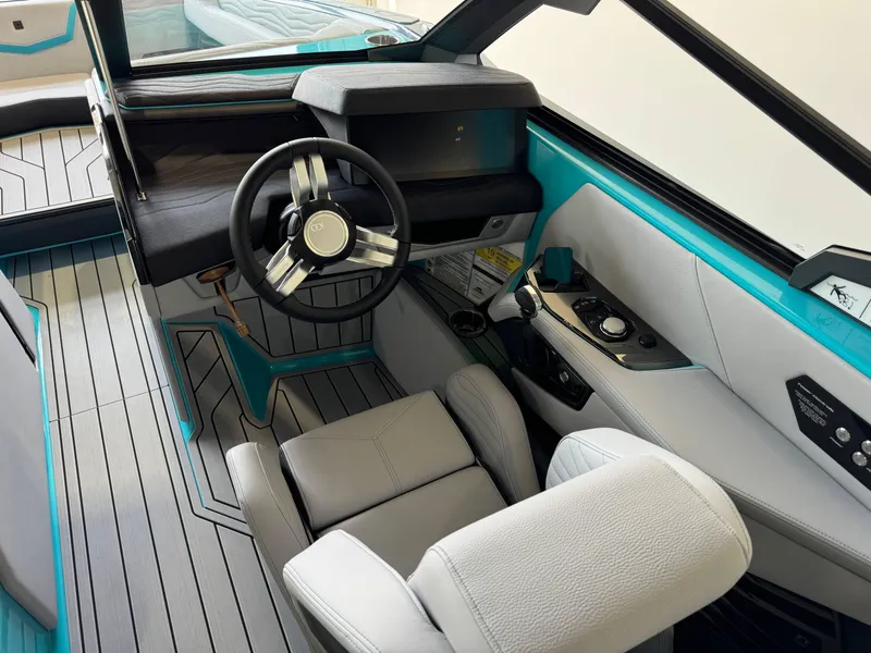 Slide: The Image of 2025 Nautique Super Air Nautique G25 cockpit with modern steering wheel and control panel. - 25
