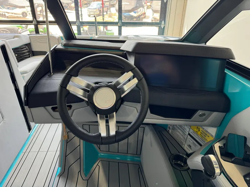 Slide: The Image of 2025 Nautique Super Air Nautique G25 helm with steering wheel and touchscreen display. - 26