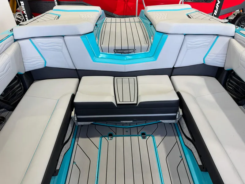 Slide: The Image of Interior seating of 2025 Nautique Super Air Nautique G25 boat with gray and turquoise upholstery. - 28