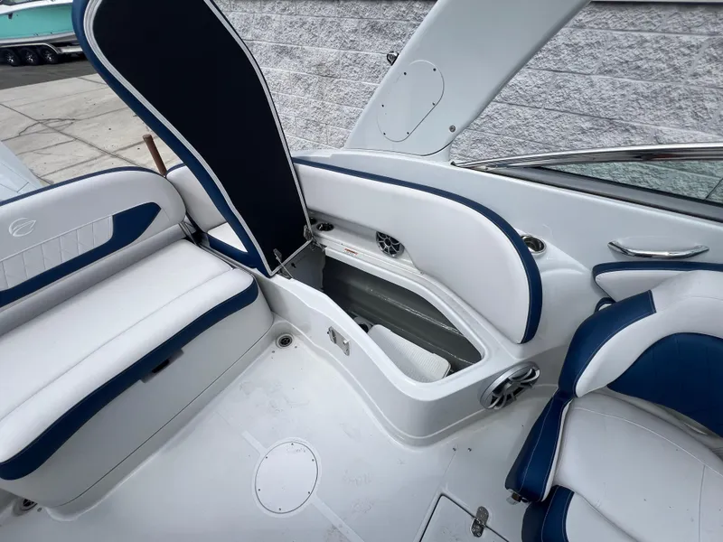 Slide: The Image of 2024 Crownline 270 XSS boat interior with open storage compartment. - 10