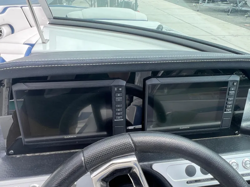 Slide: The Image of 2024 Crownline 270 XSS boat dashboard with dual Garmin displays. - 12