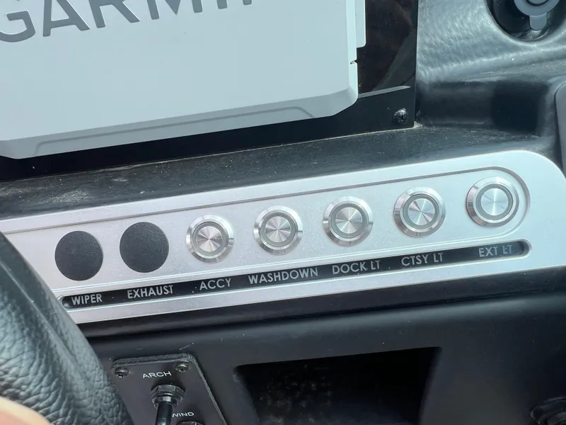 Slide: The Image of Control panel of a 2024 Crownline 270 XSS boat with labeled switches. - 14