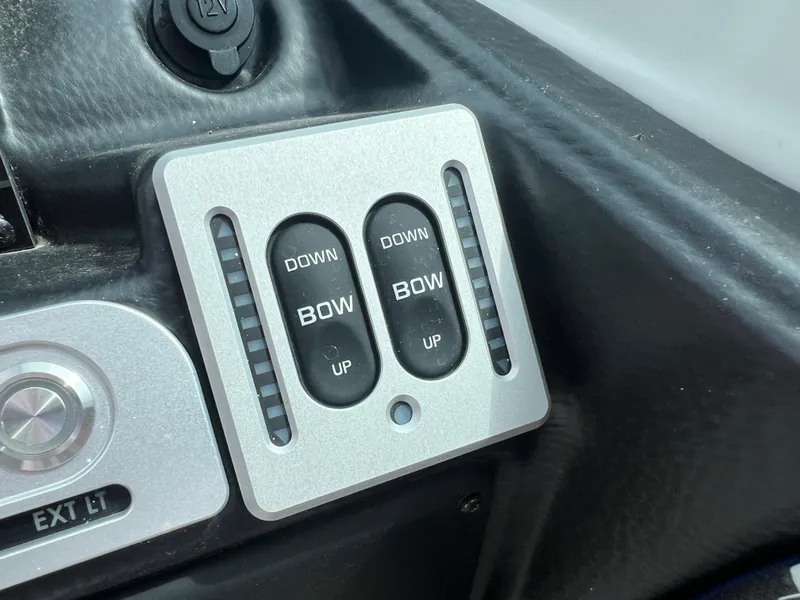 Slide: The Image of Control panel of 2024 Crownline 270 XSS boat with bow trim switches. - 16