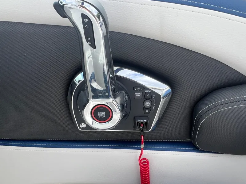 Slide: The Image of 2024 Crownline 270 XSS boat throttle control and ignition switch. - 17