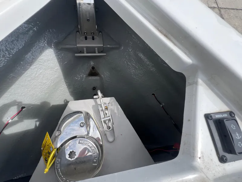 Slide: The Image of 2024 Crownline 270 XSS boat anchor compartment with winch and control panel. - 19