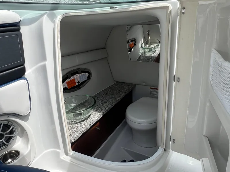 Slide: The Image of 2024 Crownline 270 XSS boat interior bathroom with granite countertop and modern fixtures. - 9