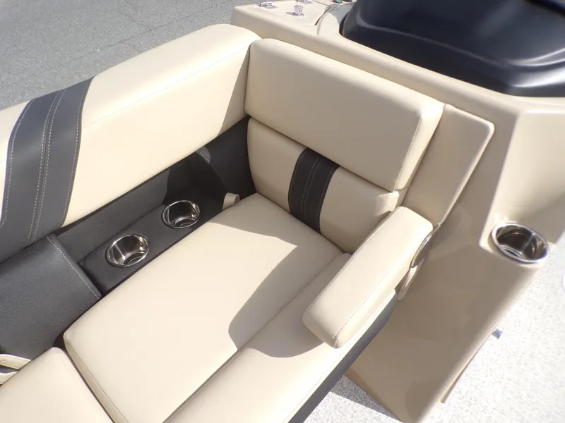 Slide: The Image of 2024 Berkshire 22RFX CTS pontoon boat with beige and black seating in a parking lot. - 10