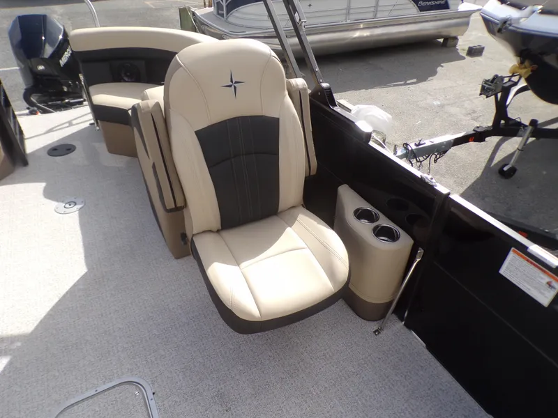 Slide: The Image of 2024 Berkshire 22RFX CTS boat interior with beige seating and cup holders. - 11