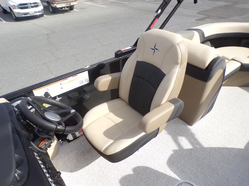 Slide: The Image of 2024 Berkshire 22RFX CTS boat interior with steering wheel and beige captain's chair. - 12