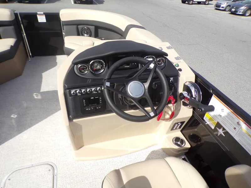 Slide: The Image of 2024 Berkshire 22RFX CTS dashboard with gauges, controls, and Lowrance display. - 13