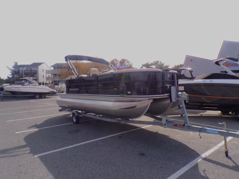 Slide: The Image of 2024 Berkshire 22RFX CTS pontoon boat for sale, black exterior, parked on trailer. - 3