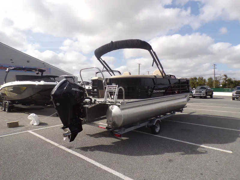 Slide: The Image of 2024 Berkshire 22RFX CTS pontoon boat on trailer, parked in a lot under cloudy skies. - 4