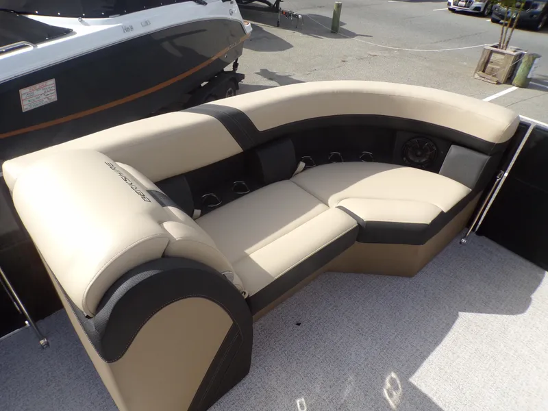 Slide: The Image of 2024 Berkshire 22RFX CTS pontoon boat interior with beige and black seating. - 9