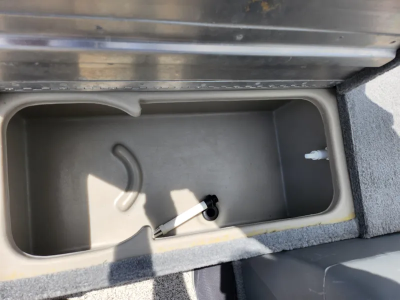Slide: The Image of 2013 Tracker Super Guide V-16 SC boat storage compartment with latch. - 15