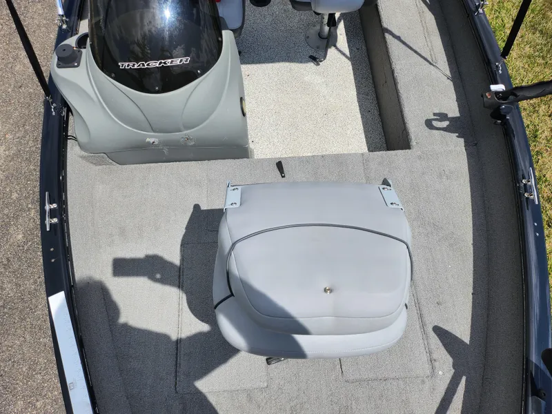 Slide: The Image of 2013 Tracker Super Guide V-16 SC boat interior with gray seating and carpet. - 17