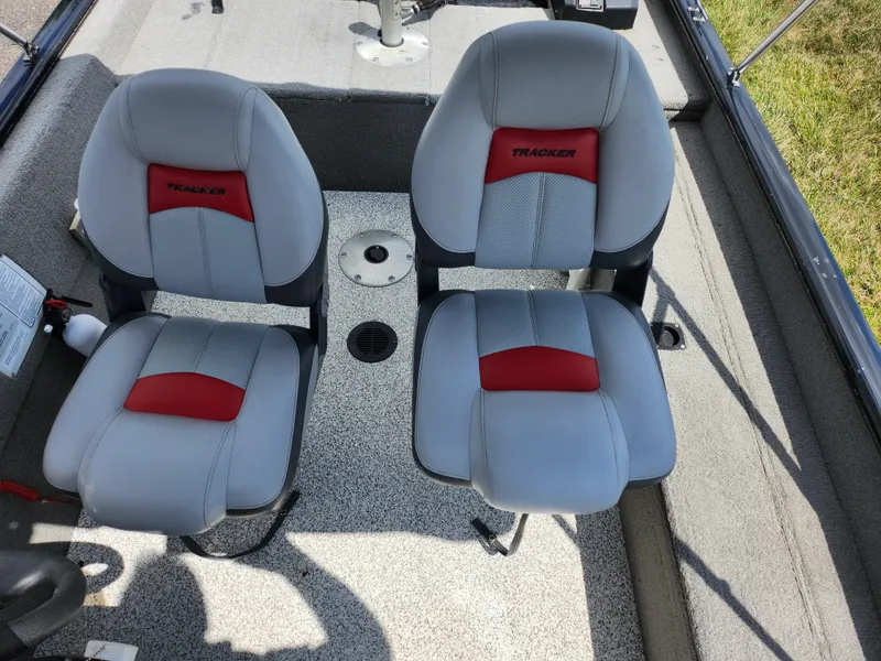 Slide: The Image of 2013 Tracker Super Guide V-16 SC boat seats, gray with red accents. - 19