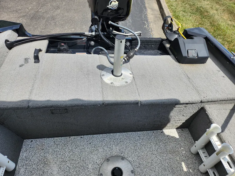 Slide: The Image of 2013 Tracker Super Guide V-16 SC boat interior with motor and storage compartments. - 20