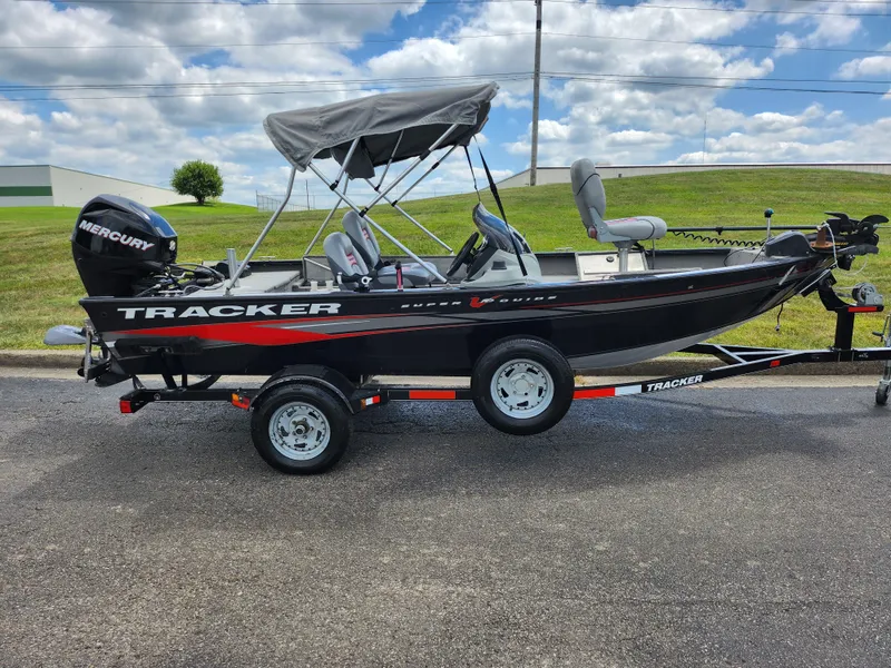 Slide: The Image of 2013 Tracker Super Guide V-16 SC fishing boat on trailer with Mercury outboard motor. - 4