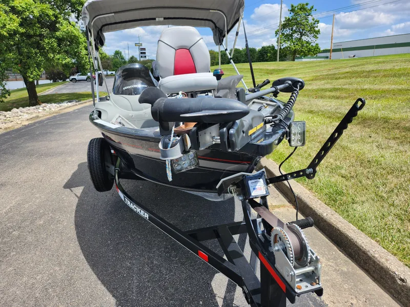 Slide: The Image of 2013 Tracker Super Guide V-16 SC boat on trailer, parked outdoors. - 6
